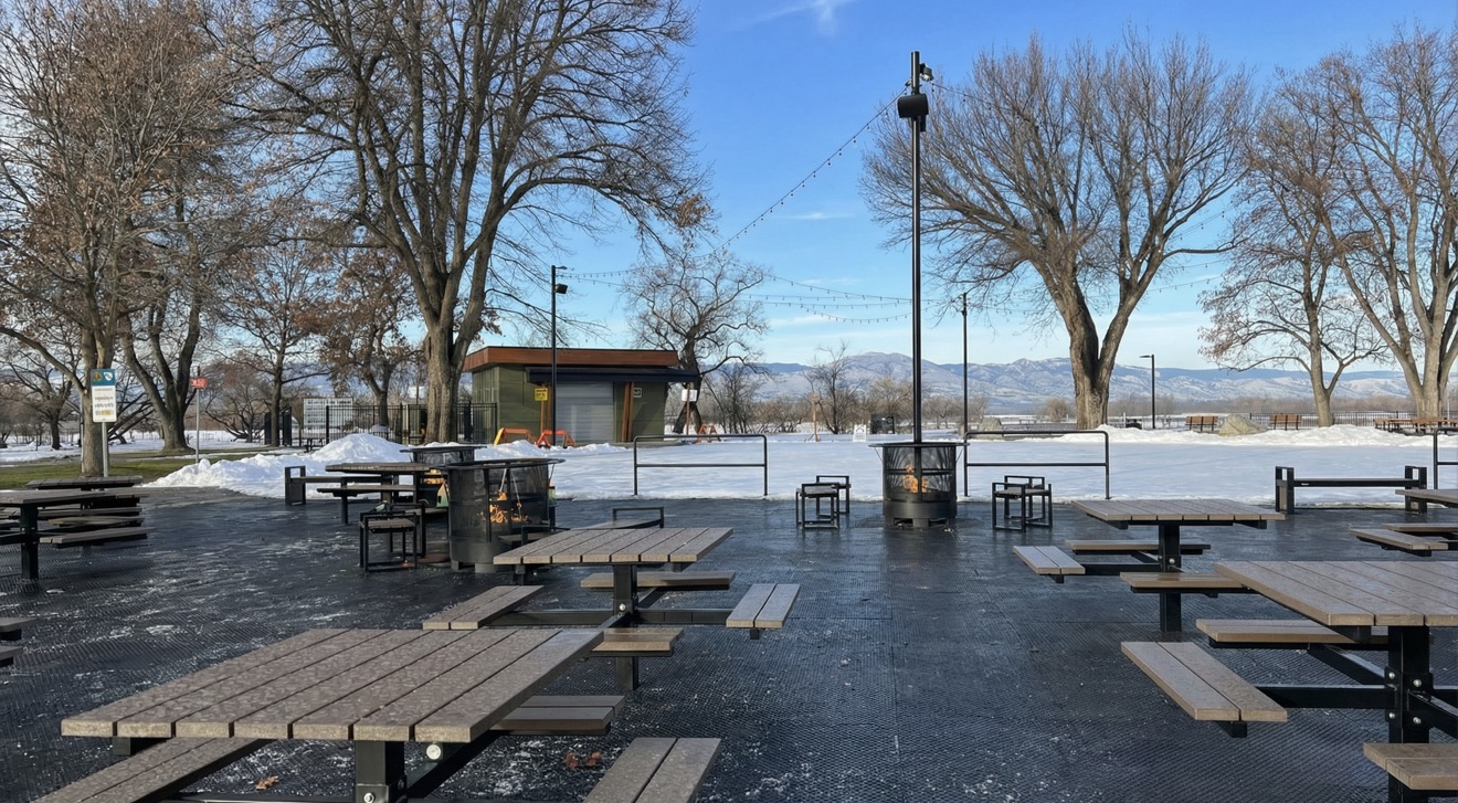 Comfortable seating area with fire pits next to the Riverside Park outdoor skating rink